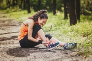 Woman with an ankle injury while jogging