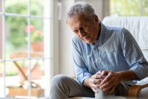 Senior man with knee replacement pain
