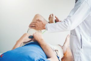 Doctor treating a patient's knee