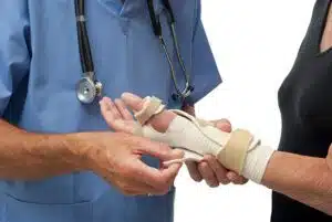 orthopedic doctor attending to female patient's wrist splint