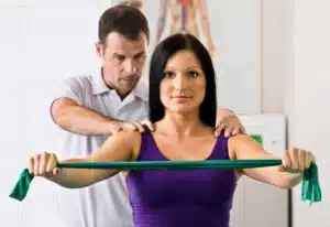 Physical Therapist Helping a Female Patient With Shoulder Pain (rotator cuff)